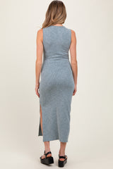 woman wearing a slate blue ribbed maternity maxi dress with side slits, showing a fitted silhouette from the back