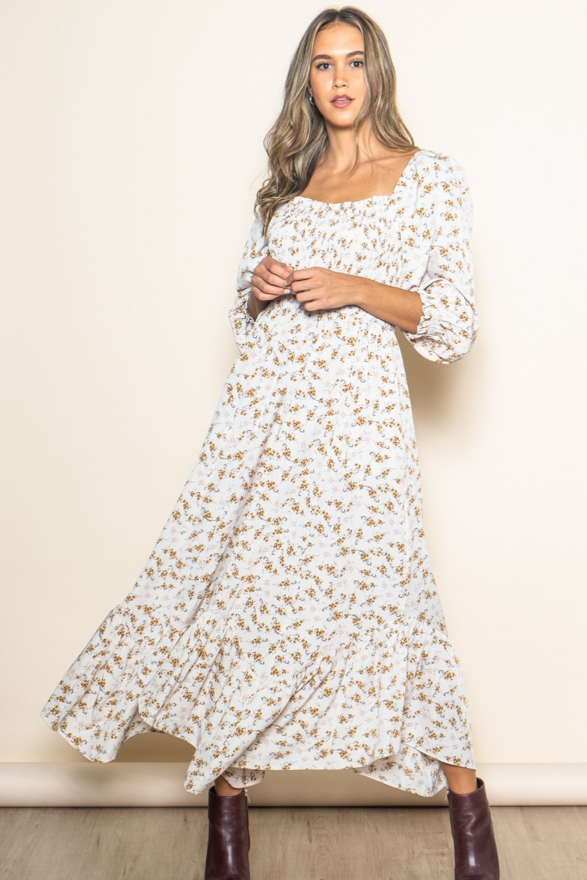 woman wearing a white floral maxi dress with puff sleeves and a smocked bodice