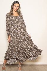 woman wearing a brown floral maxi dress with long sleeves and a smocked bodice
