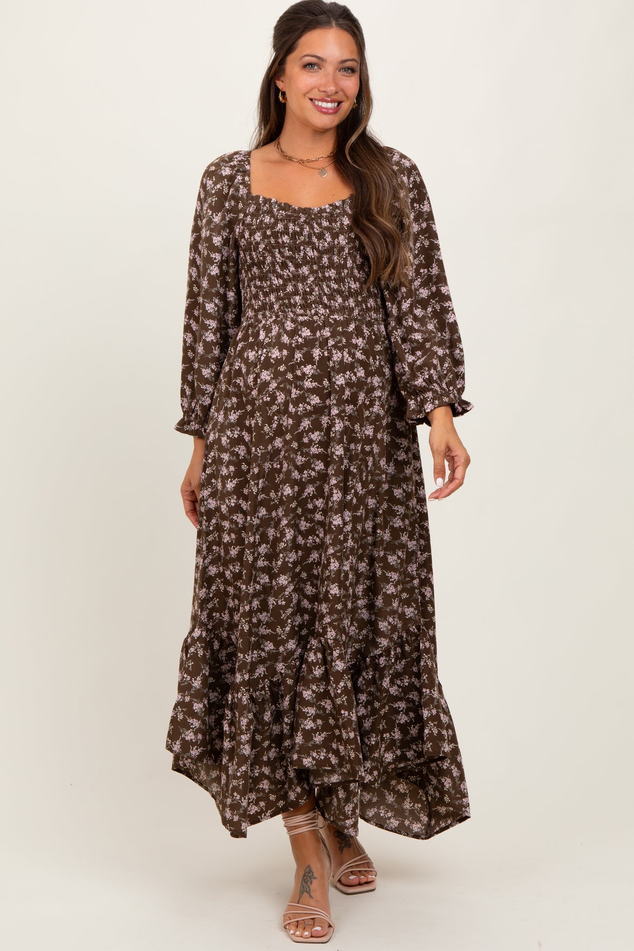 woman wearing a brown floral maternity maxi dress with a square neckline and puff sleeves