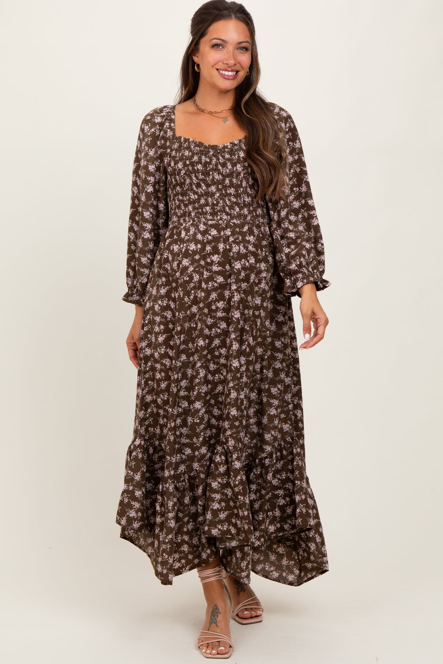 woman wearing a brown floral maternity maxi dress with a square neckline and puff sleeves