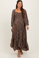 woman wearing a brown floral maternity maxi dress with a square neckline and puff sleeves