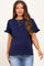 woman wearing a navy blue maternity top with ruffled sleeves and a visible baby bump