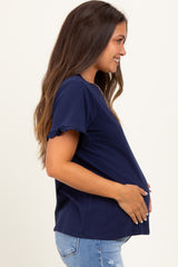 woman wearing a navy blue maternity top with ruffle sleeves and holding her baby bump