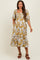 woman wearing a mustard floral print maternity dress with puff sleeves and a tiered hemline