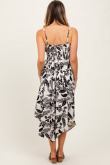 woman wearing a black and white floral maxi sundress with a smocked back and adjustable straps