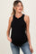woman wearing a black ribbed maternity tank top and jeans, showing her baby bump