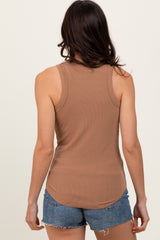 woman wearing a brown ribbed tank top and blue denim shorts, seen from the back