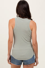 woman wearing a light green ribbed tank top and denim shorts, view from the back