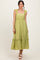 woman wearing a light green maxi dress with ruffled straps and a tiered skirt