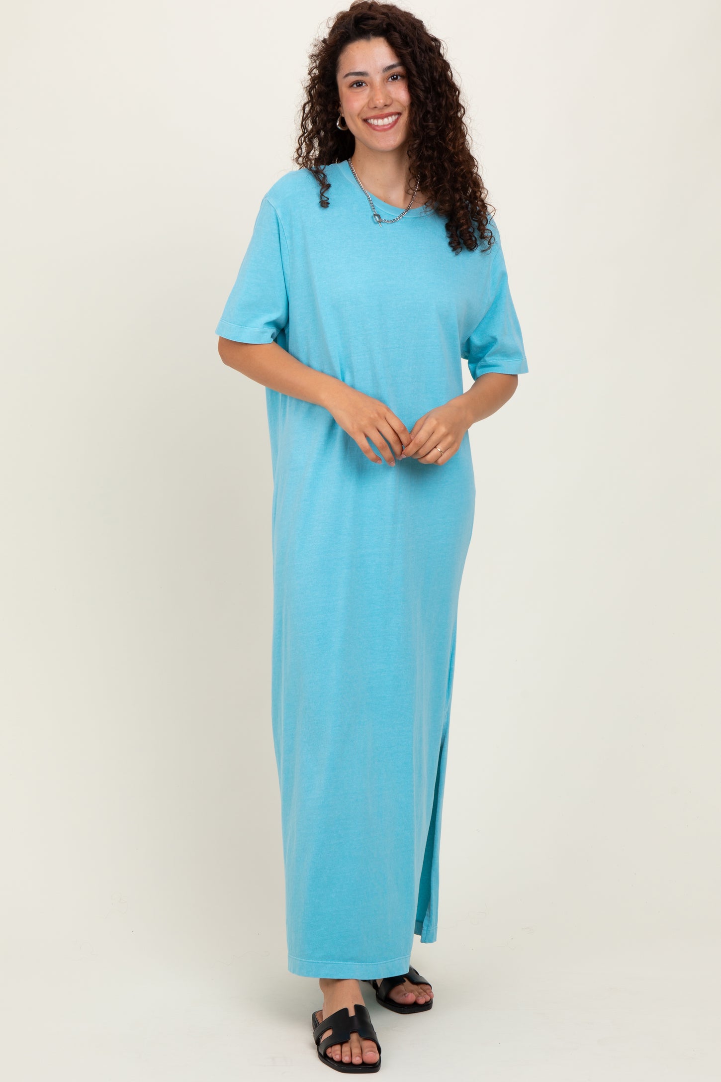 woman wearing a light blue oversized t-shirt dress with short sleeves and side slits
