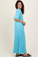 woman wearing a blue short sleeve maxi dress with a relaxed fit and side slits