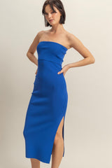 woman wearing a bright blue strapless midi dress with a side slit