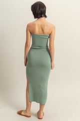 woman wearing a mint green strapless midi dress with a side slit, shown from the back
