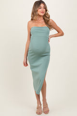 woman wearing a mint green strapless maternity dress with a side slit and showing her baby bump