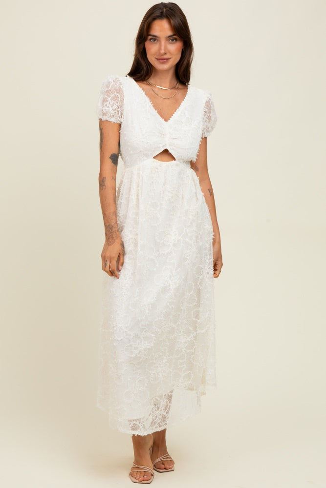 woman wearing a white lace midi dress with short puff sleeves and a front cutout detail