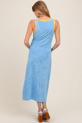 woman wearing a blue tank dress with yellow straps, showing the back, suitable for maternity wear