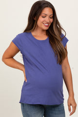 woman wearing a purple short sleeve maternity top and showing her baby bump
