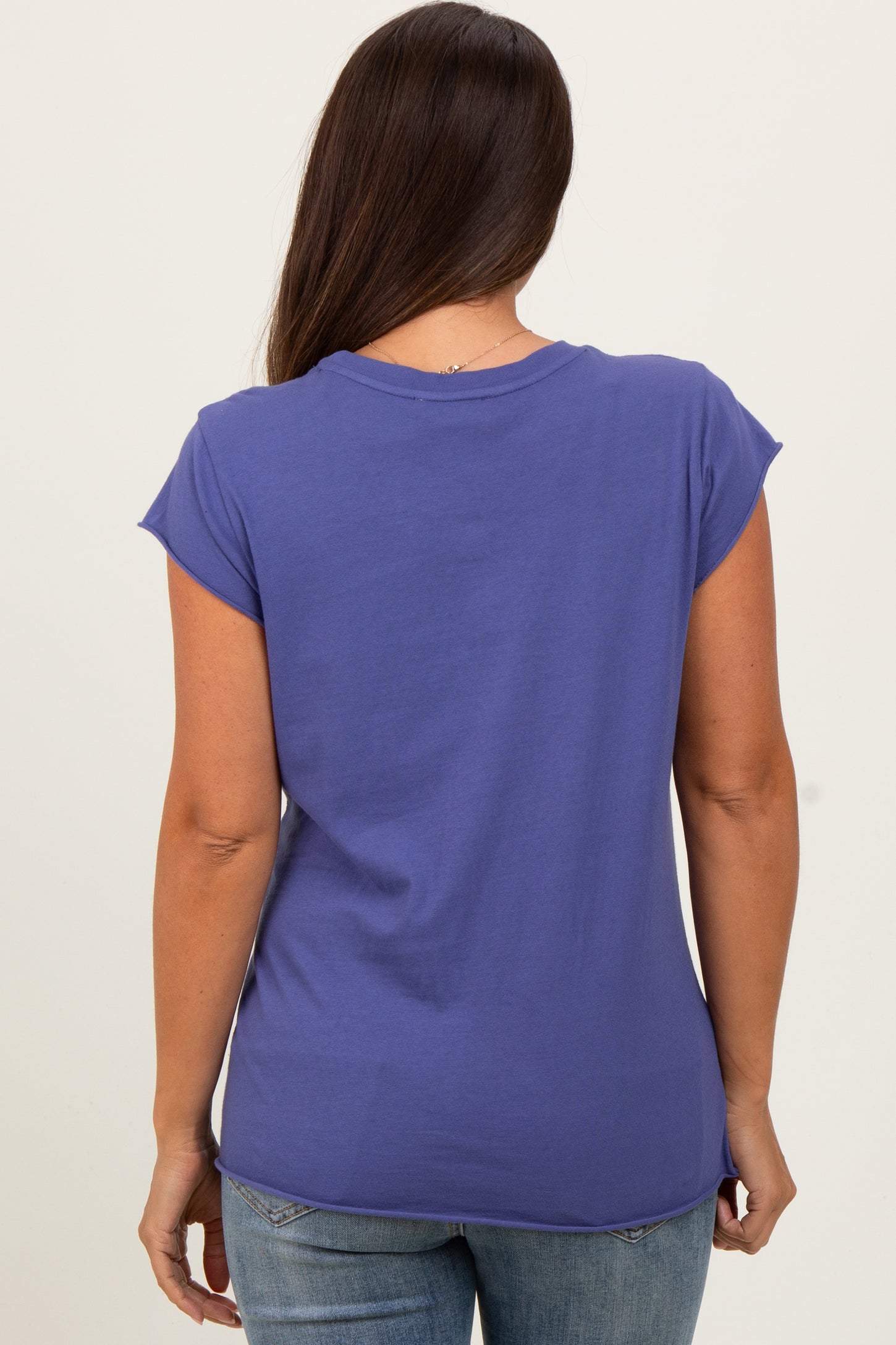 woman wearing a purple cap sleeve maternity top, showing the back view