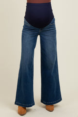 woman wearing dark blue maternity wide-leg jeans with a stretchy high waistband