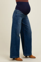 woman wearing dark blue wide-leg maternity jeans with a navy belly panel and visible baby bump