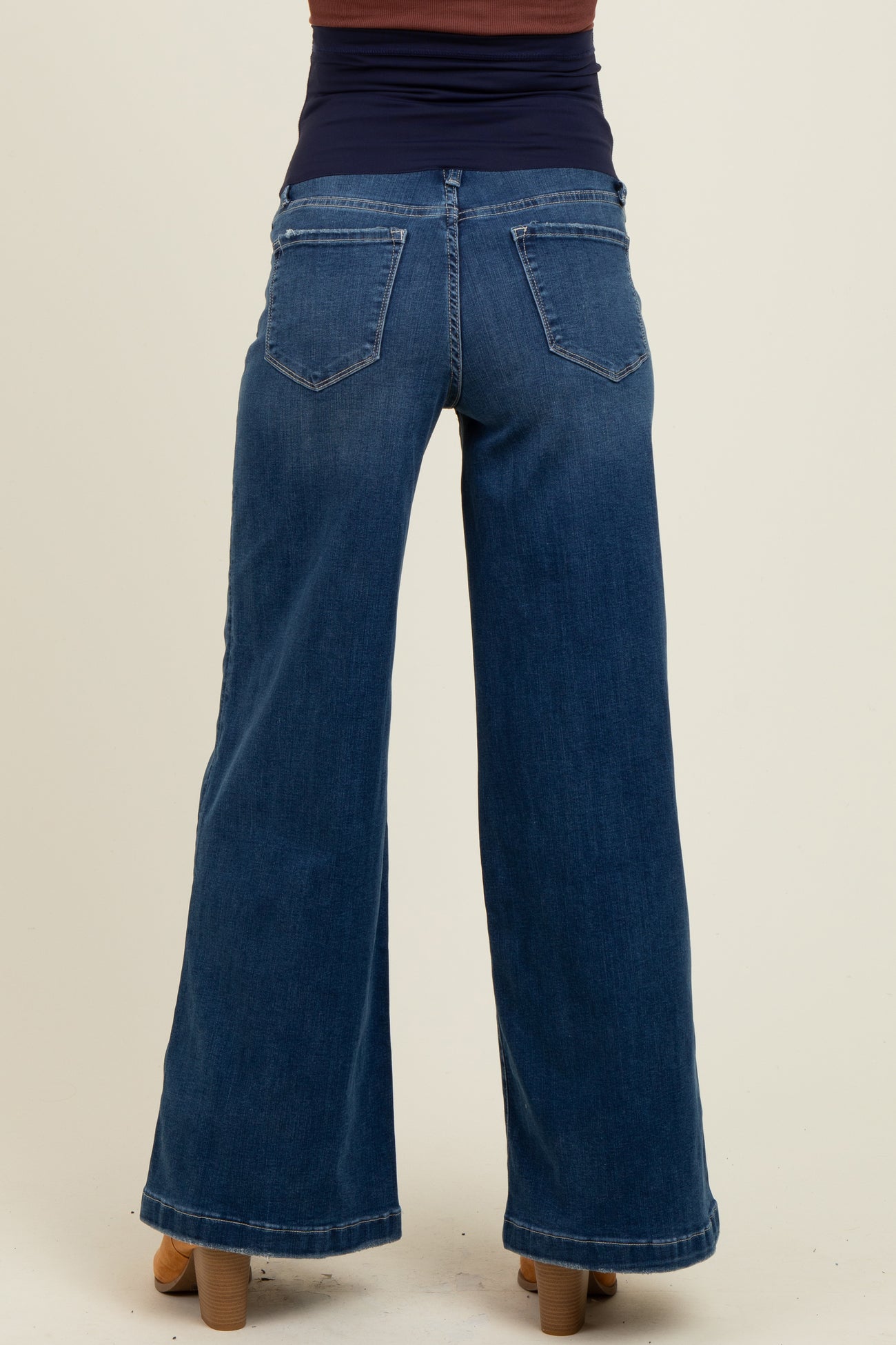 woman wearing dark blue wide-leg maternity jeans, showing the back view
