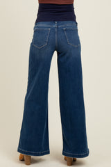 woman wearing dark blue wide-leg maternity jeans, showing the back view