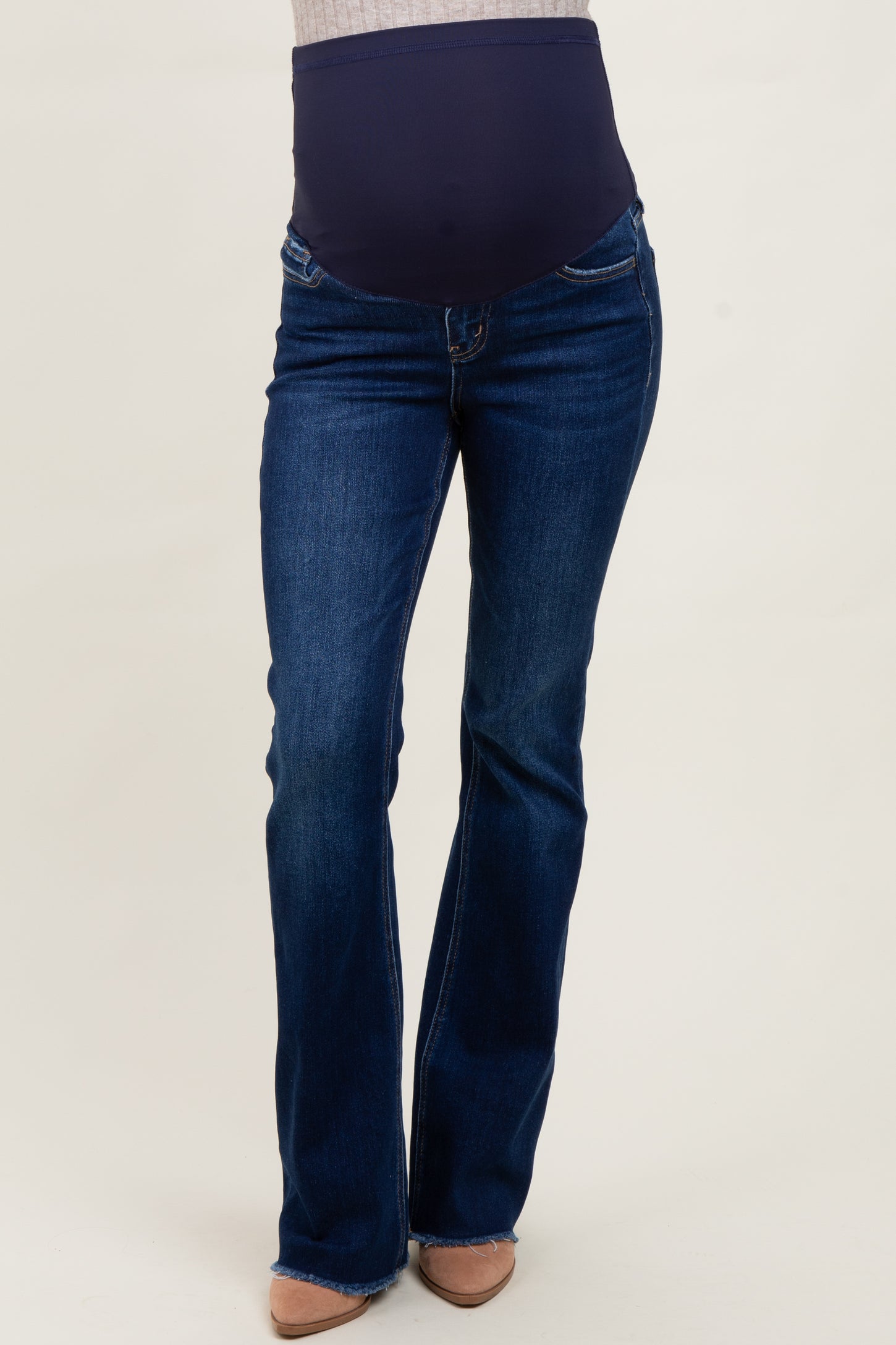 woman wearing dark blue maternity bootcut jeans with a supportive over-the-bump waistband
