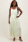 woman wearing a pale green maxi dress with a gathered bodice and tie waist detail