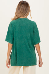 woman wearing a green oversized maternity t-shirt with a relaxed fit, showing the back view