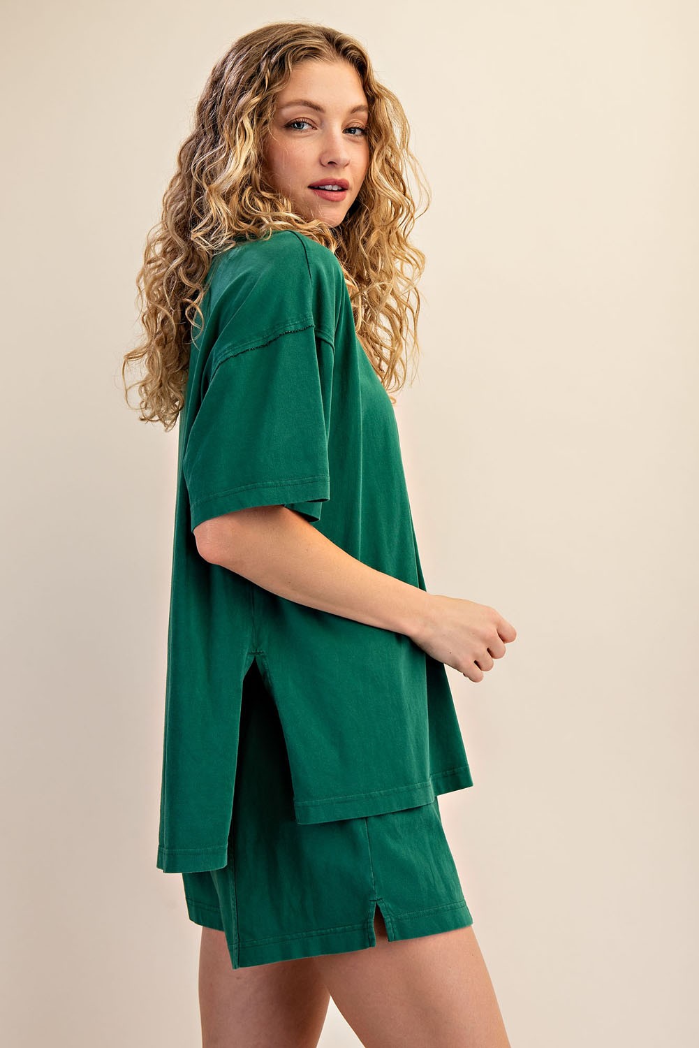 woman wearing a green oversized t-shirt with side slits and matching green shorts