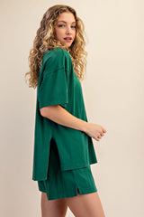 woman wearing a green oversized t-shirt with side slits and matching green shorts