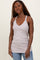 woman wearing a light gray tank top with a deep v-neck and slim fit, styled with blue jeans