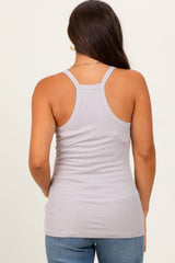 woman wearing a light gray maternity tank top with a racerback style and fitted silhouette
