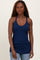 woman wearing a navy blue ribbed tank top with a v-neck and thin straps paired with jeans