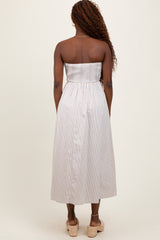 woman wearing a striped strapless midi dress with a smocked bodice and back view, styled with wedges