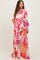 woman wearing a floral maternity dress with long sleeves and a tied waist, showcasing her baby bump