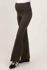 woman wearing olive green maternity flared pants with a supportive waistline and comfortable fit, showcasing her baby bump