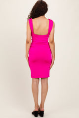 woman wearing a hot pink form-fitting dress with a low back and knee-length hem
