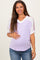woman wearing a lavender maternity top with lace detail on sleeves and showing her baby bump