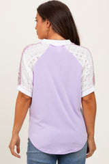 woman wearing a lavender maternity top with lace short sleeves, showing a relaxed fit from the back