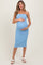 woman wearing a light blue strapless maternity dress and holding her baby bump