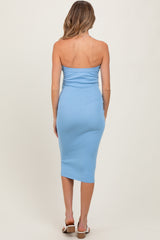 woman wearing a light blue strapless midi maternity dress, viewed from the back