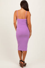 woman wearing a fitted purple ribbed midi maternity dress with spaghetti straps, model seen from the back