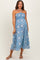 woman wearing a blue patterned strapless maternity dress with a flowing silhouette and a fitted bodice