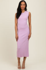 woman wearing a light pink sleeveless ribbed midi dress with a fitted silhouette and a slight flare at the hem