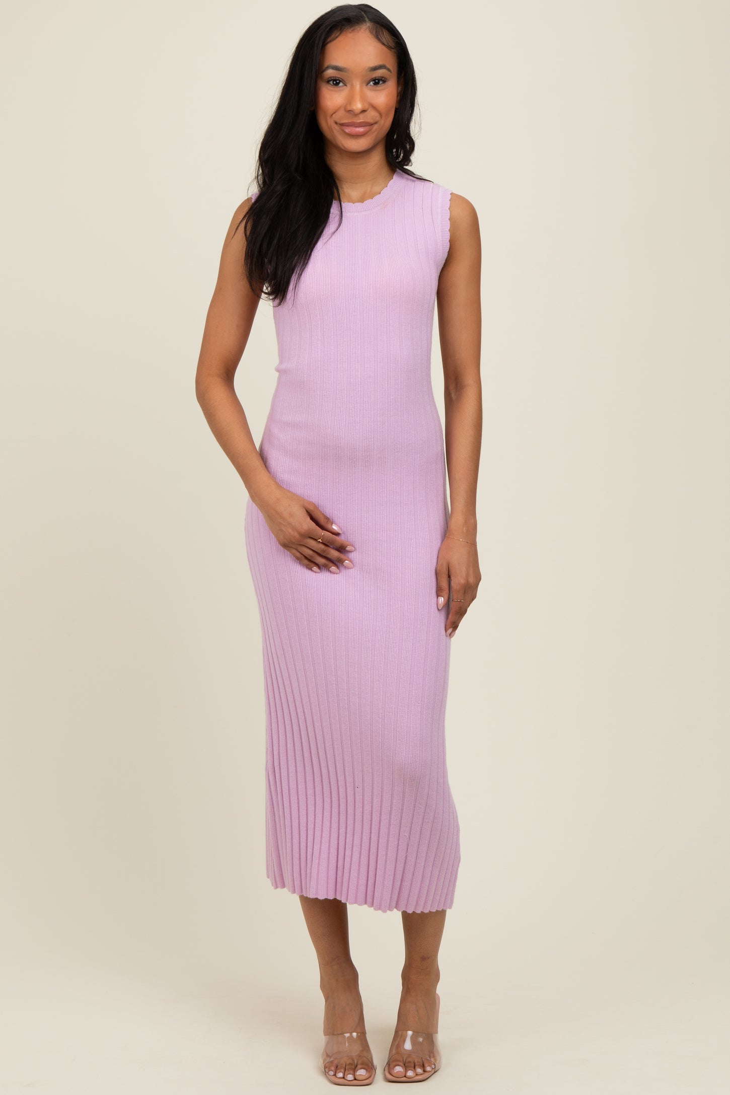 woman wearing a sleeveless light purple ribbed midi dress and holding her baby bump