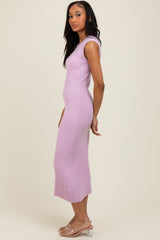 woman wearing a light purple ribbed midi dress with a fitted silhouette and side slit
