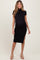 woman wearing a black ribbed maternity dress with short sleeves and a side slit, showing her baby bump