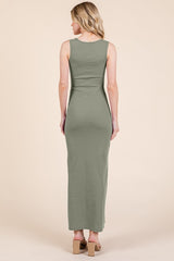 woman wearing a form-fitting olive green maxi dress, shown from the back, with a sleek silhouette and no sleeves